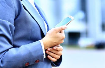 young business woman using mobile phone outdoor modern solutions