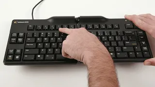 A man pointing out Mac Specific Keys on the Goldtouch Elite Keyboard.