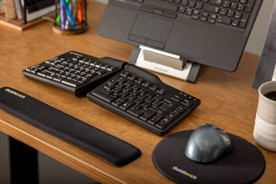 Goldtouch lifestyle image featuring the Elite Keyboard, FlexMouse, Laptop Stand, and Wrist Rest.