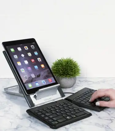 Goldtouch Go!2 Mobile Keyboard with a Goldtouch Laptop Stand and an iPad on the stand lifestyle image.